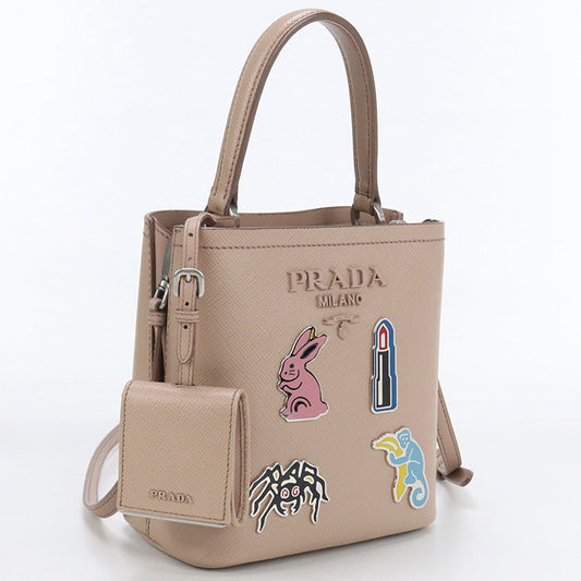 Beige Prada handbag with colorful patches on a white background