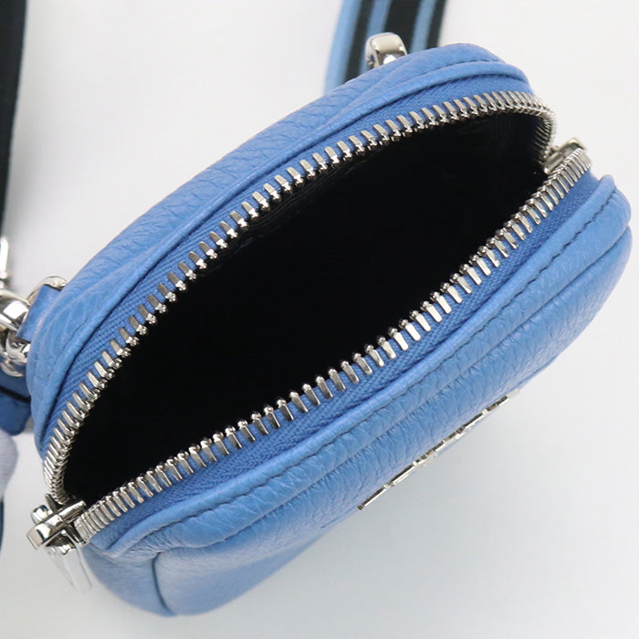 Blue handbag with a silver zipper on a light gray background