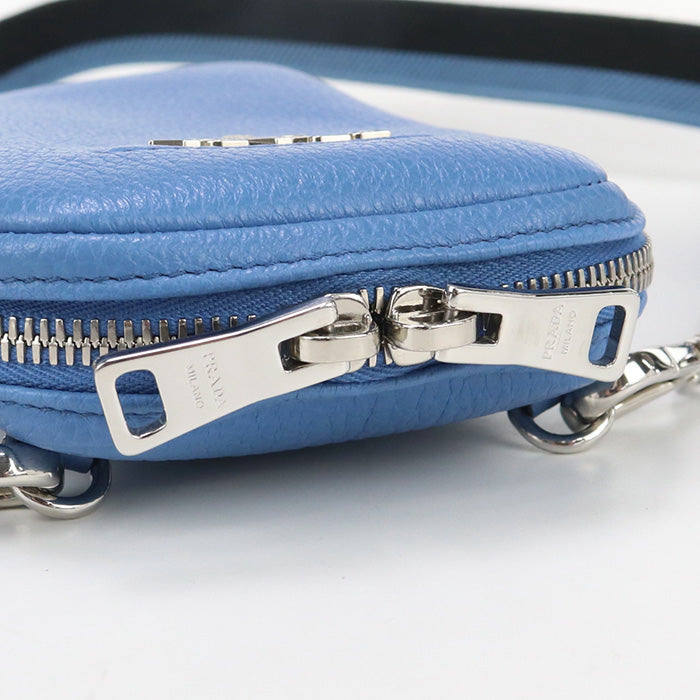 Close-up of a blue textured pouch with a silver zipper on a white background
